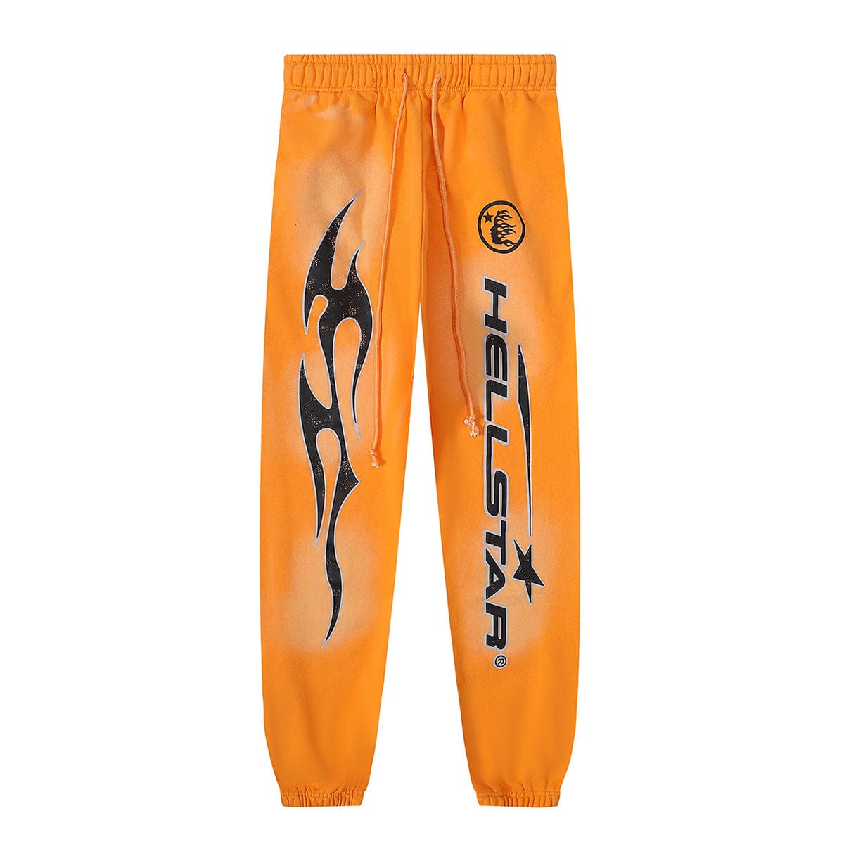 The Hellstar Orange Tribal Flame Graphic Jogger Sweatpants feature bold orange fabric, a fiery tribal flame graphic, "HELLSTAR" text, small circular logo, and an elastic drawstring waistband for standout style.