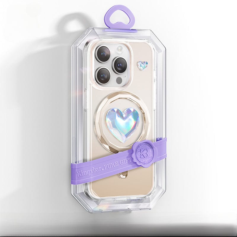 The gold iPhone 16 Pro Max is encased in a crystal-clear protective case featuring AI precision button cutouts, showcasing a purple heart-shaped pop socket with a "PURE GIRL" band.