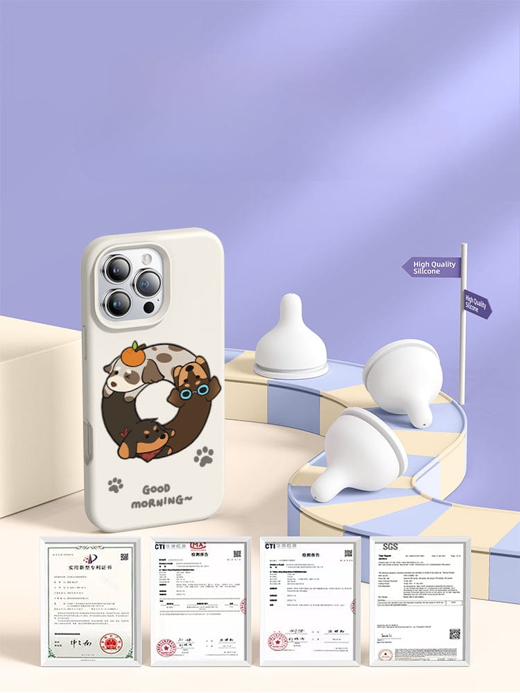 An iPhone 16 Pro Max case featuring a Good Morning cartoon dog design sits beside baby bottle nipples on a pastel-themed background. Various certificates are displayed at the bottom. Text reads "High Quality Silicone" and "Good Morning." Enjoy 360° full-coverage with triple-layer shockproof protection, thanks to its shockproof and anti-yellowing, washable silicone design.