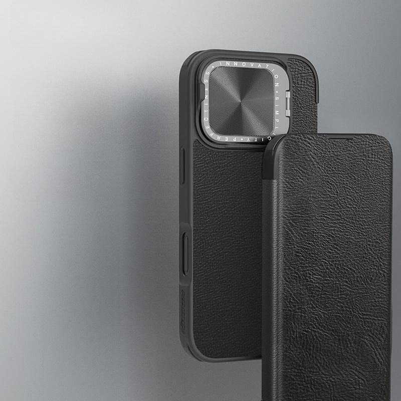 An iPhone 16 Pro Max Leather Flip Case with a card holder is shown partially open, revealing the smartphone's camera module with a metal lens cover. The black, premium leather exterior offers full protection against everyday wear and tear. The background is a plain, light grey surface.