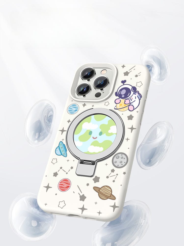 An iPhone 16 Pro Max in a Pink Silicone MagSafe Case with Stand, featuring a space theme complete with planets and stars, rests in an open beige box with an additional slot for another phone or accessory.