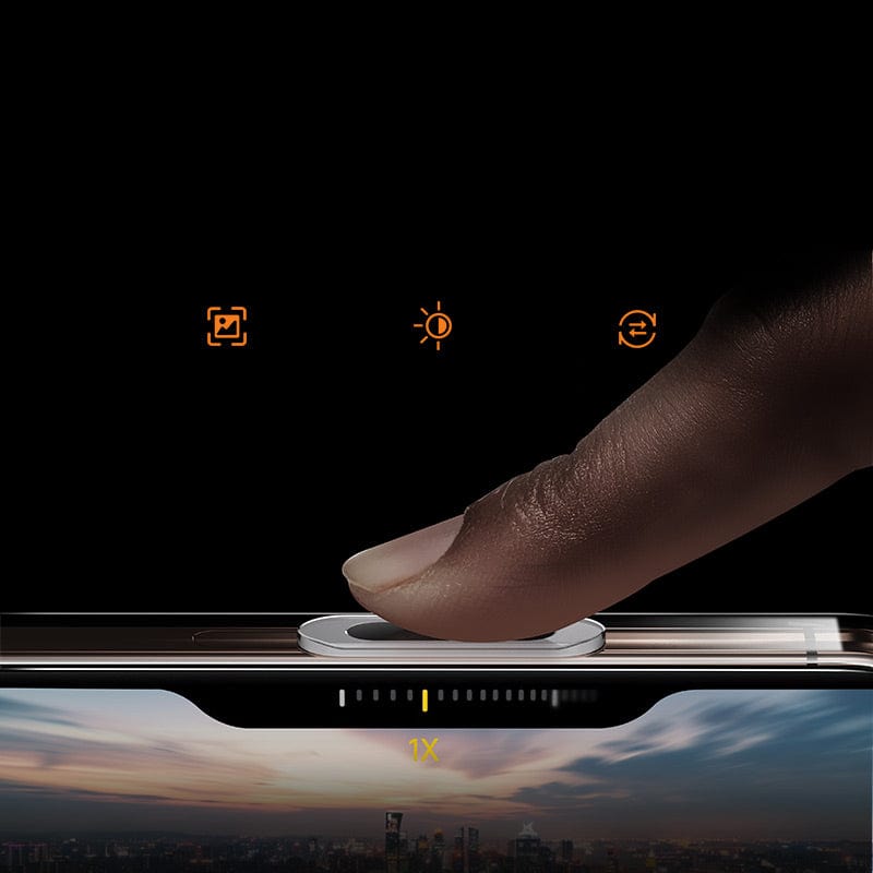 A close-up of a finger pressing the responsive camera button on an iPhone 16 Pro Max Clear Case, with camera interface icons visible above and an image of a cityscape displayed on the screen below. The AR-coated anti-fingerprint surface ensures a clear view of your stunning shot while its anti-yellowing feature keeps it looking pristine.