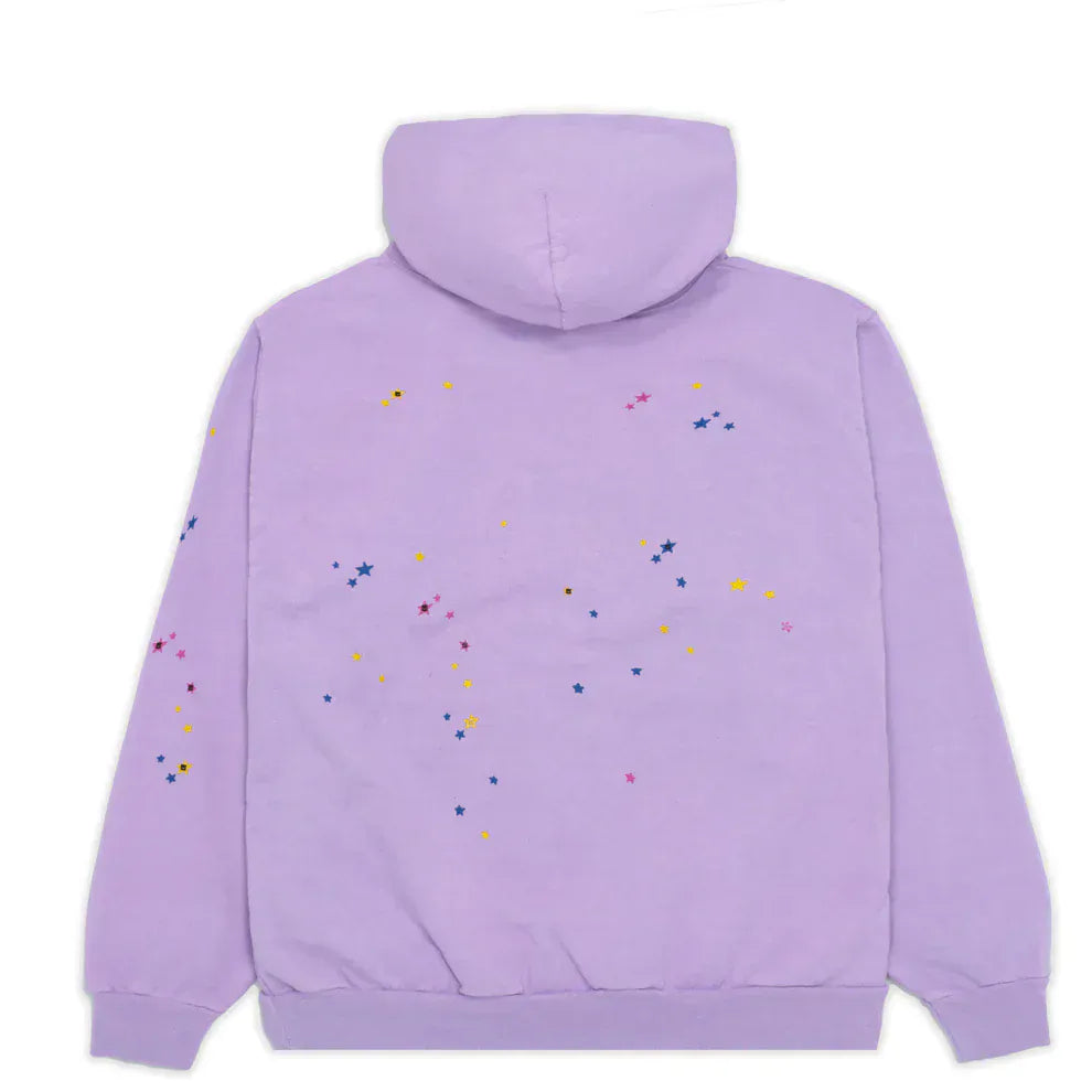 The Sp5der “Hares the Slime” Hoodie is a lavender purple 440GSM heavyweight streetwear pullover with scattered blue, pink, and yellow stars on the back and left sleeve, featuring signature spider-web style for cozy comfort.