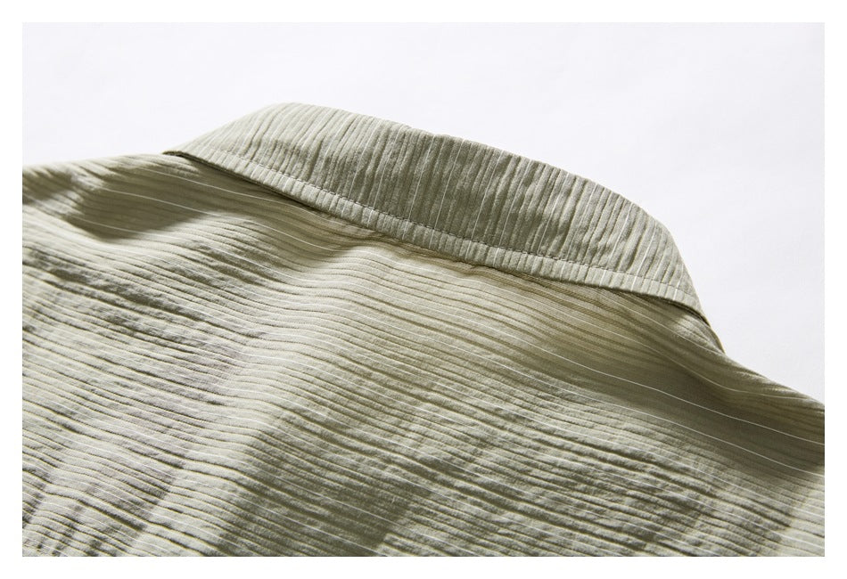 Close-up of the muted olive-gray shirt collar with narrow textured stripes and visible stitching.