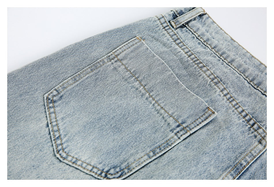 Close-up of a single rear pocket on light blue jeans with visible contrast stitching.