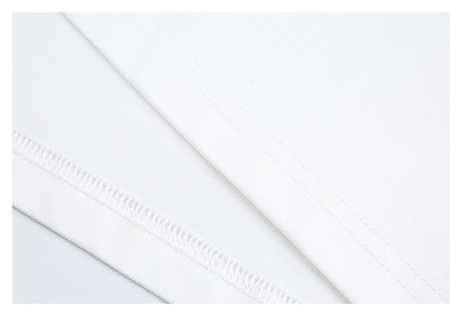 Close-up of white fabric with a folded hem and visible overlock stitching.