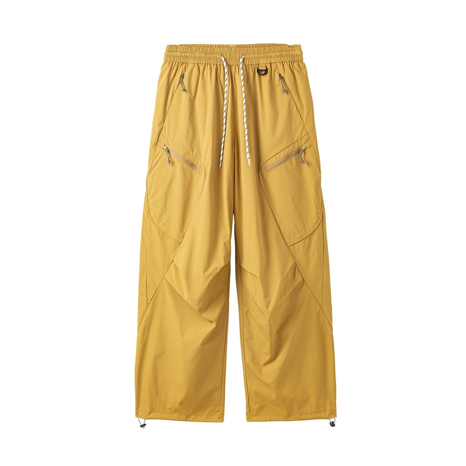 Yellow wide-leg drawstring pants with diagonal zip hip pockets and toggle hems, front flat view