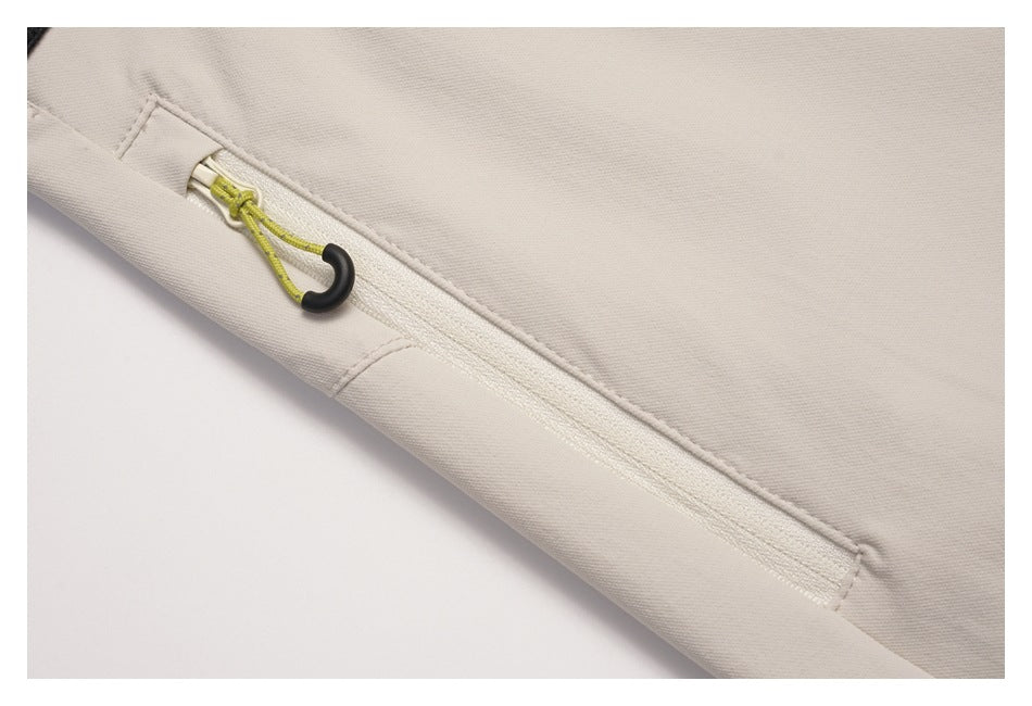 Close-up of the skirt's zipper pocket with a bright green cord pull and black ring.