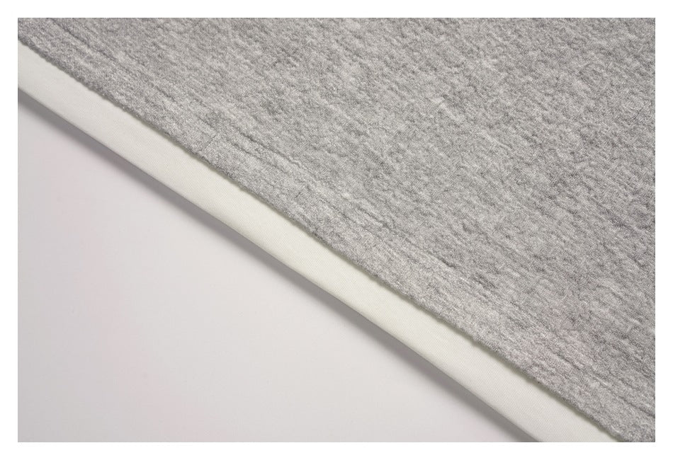 Close-up of the gray sweatshirt edge with a white layer visible underneath.
