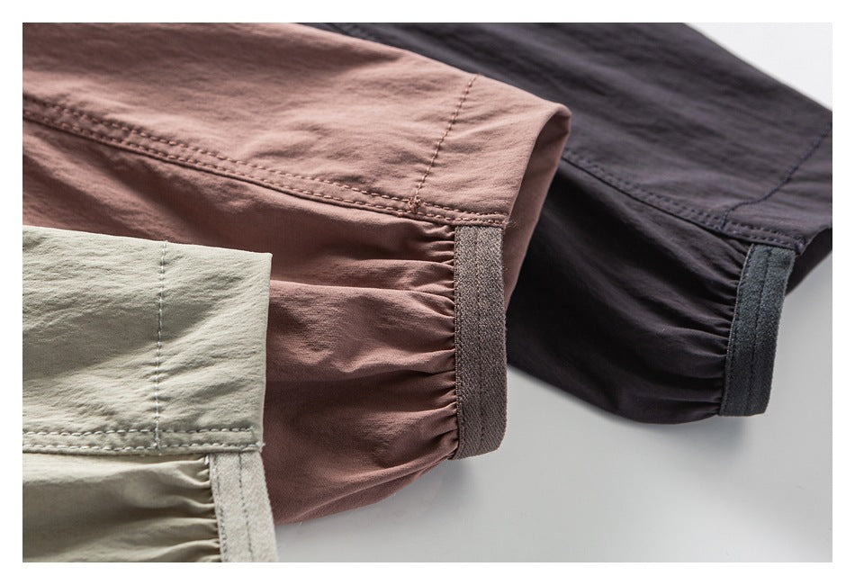 Three jacket sleeve cuffs in pale sage, dusty mauve, and charcoal, showing gathered fabric and hook-and-loop tabs.