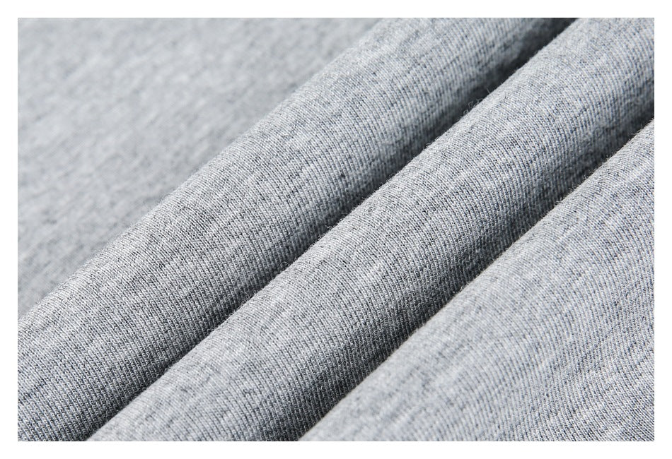 Close-up of heather gray knit fabric folded into soft diagonal ridges.