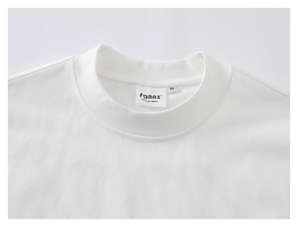 Close-up of the white T-shirt's ribbed crew neck, shoulder seams, and sewn-in neck label.