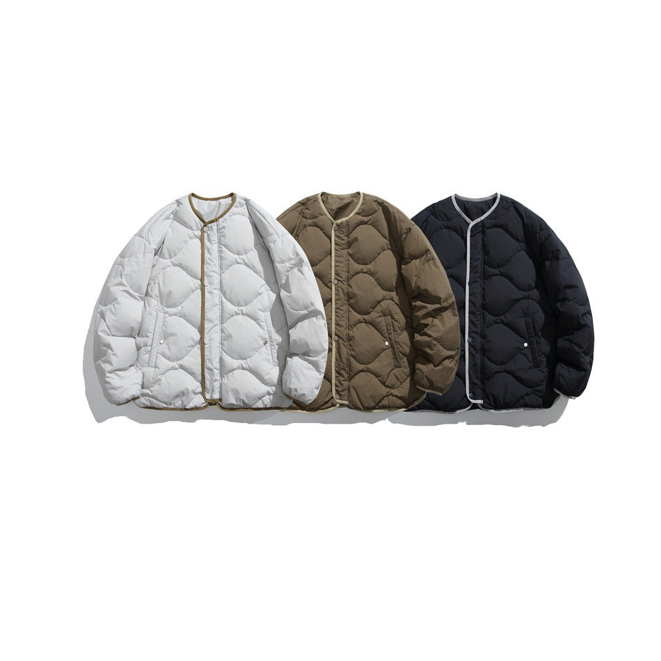 Three quilted snap-front jackets shown together in pale gray, taupe, and black, each with contrasting edge trim.