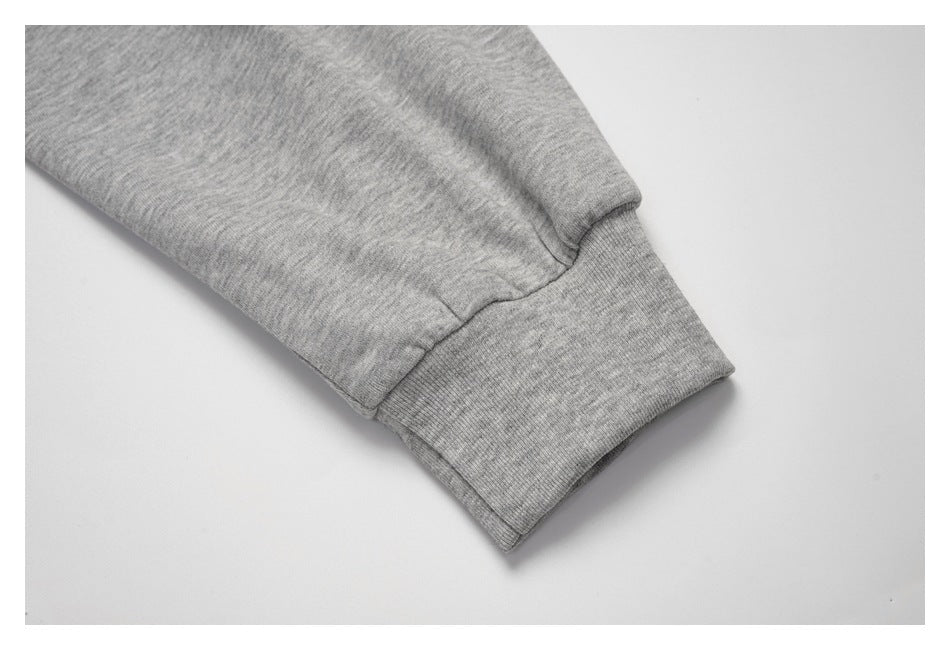 Close-up of a heather-gray sleeve ending in a ribbed cuff.
