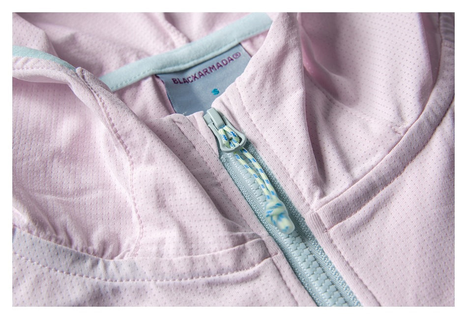 Close-up of the jacket neckline, BLACKARMADA label, and mint zipper with a patterned pull cord.