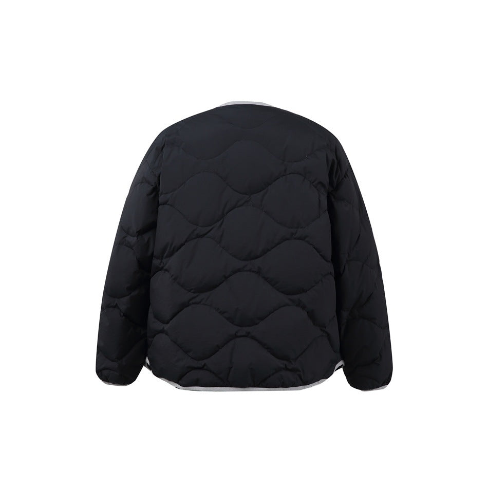 Back view of black quilted jacket with wavy quilting and gray trim at neckline and hem
