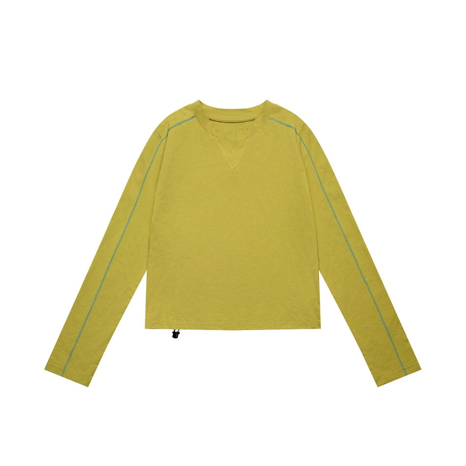 Yellow-green cropped long-sleeve top flat lay with teal sleeve stitching and a hem drawstring toggle