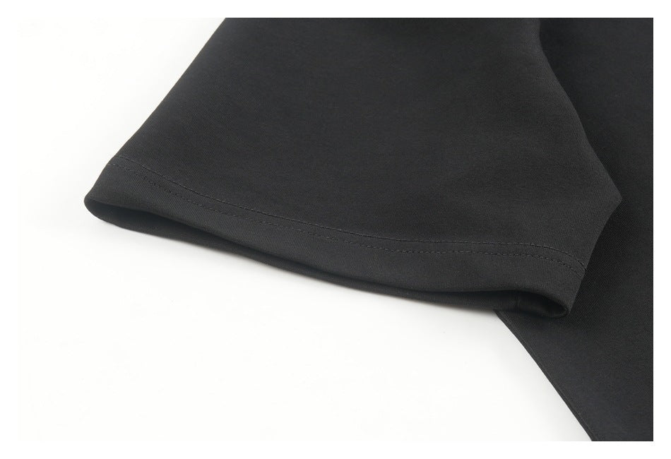 Close-up of a black garment sleeve with a double-stitched hem.