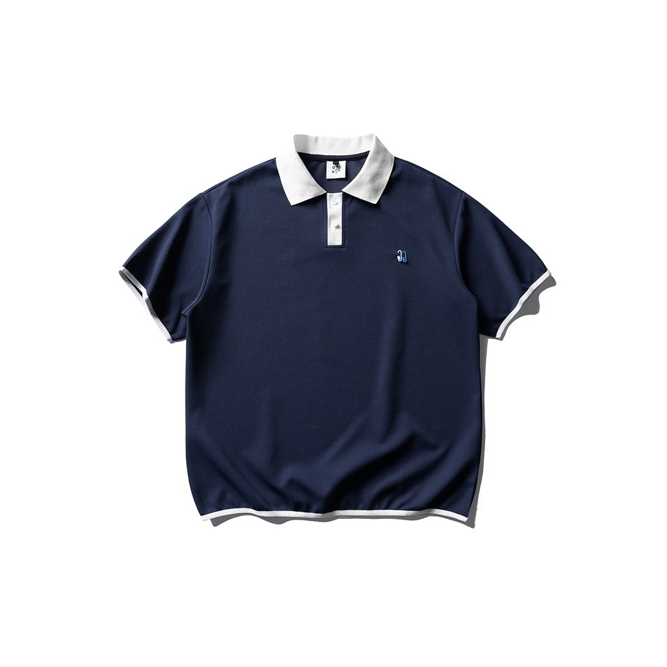 Navy short-sleeve polo with white collar, placket panel and white trim on sleeves and hem, flat lay front view