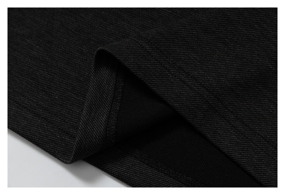 Close-up of a folded edge showing the black fabric's reverse and stitched seam.