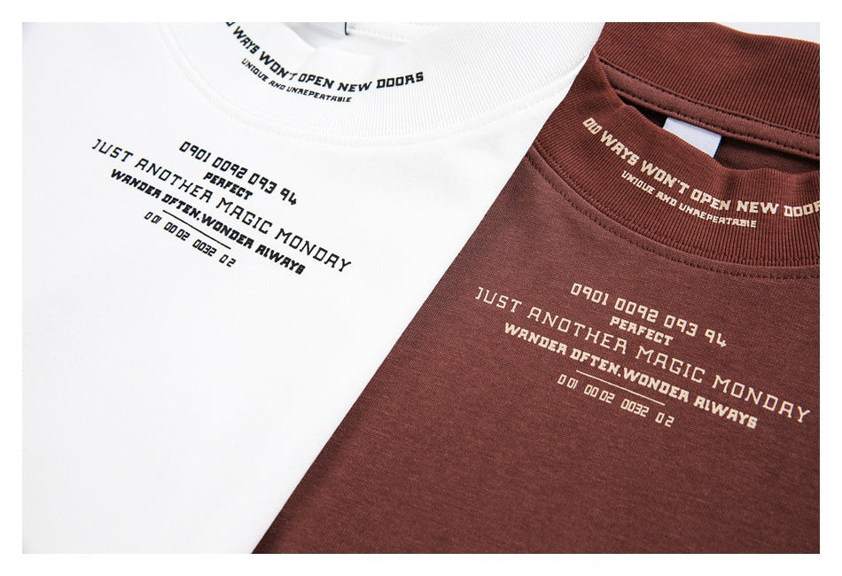 Close-up of white and burgundy T-shirts showing small English chest prints and text inside the collars.