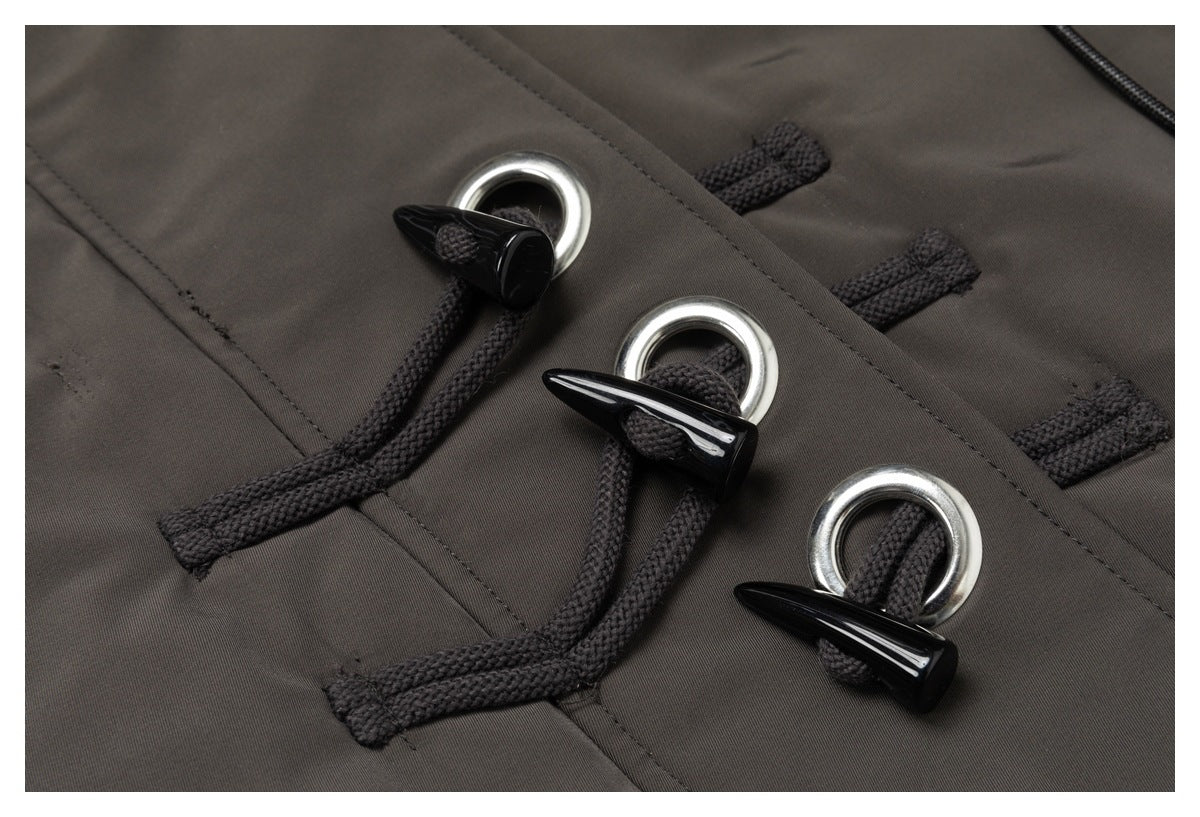 Three black cord toggle closures with silver rings on a dark charcoal-brown jacket.