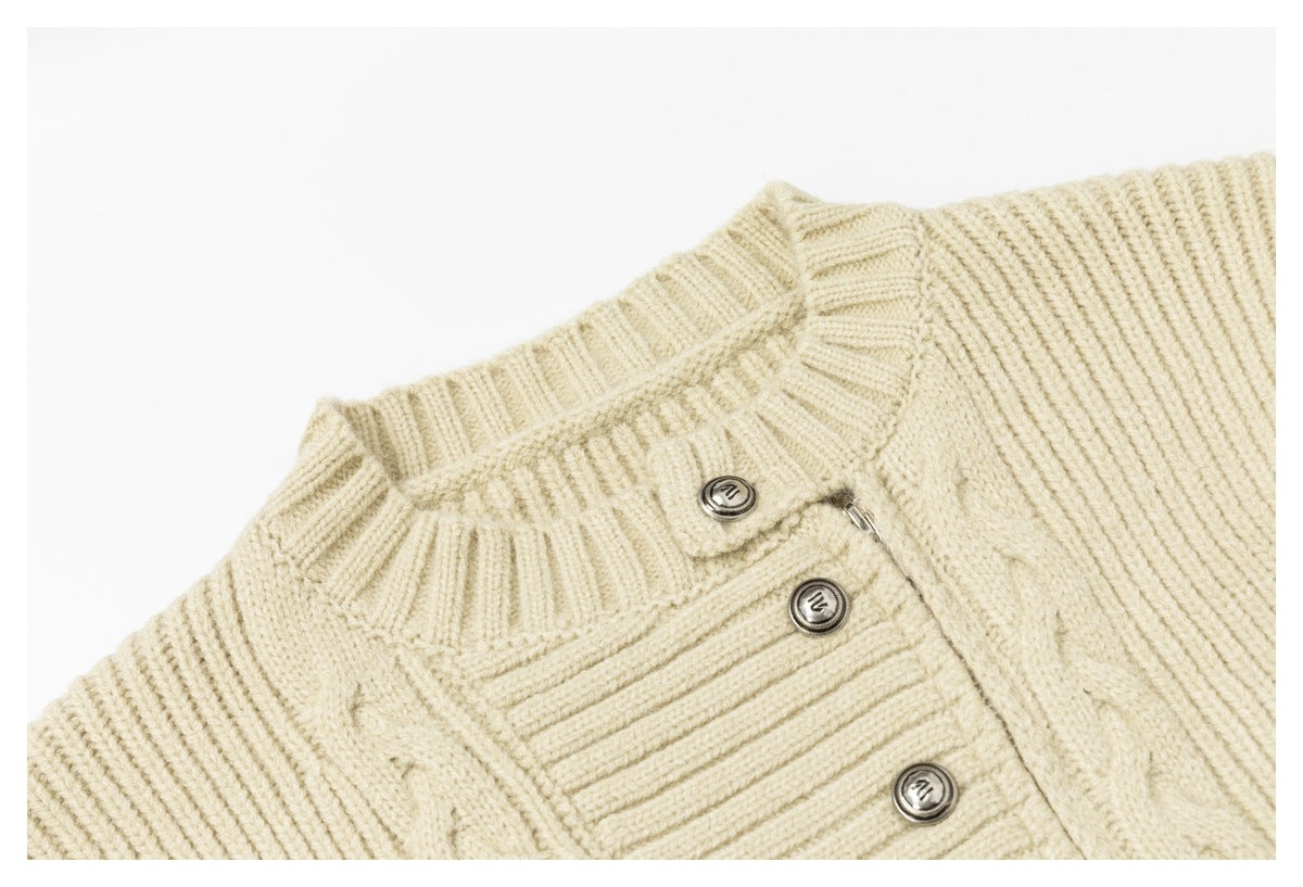 Close-up of the ivory cardigan's ribbed collar, cable-knit panels and metallic button placket.
