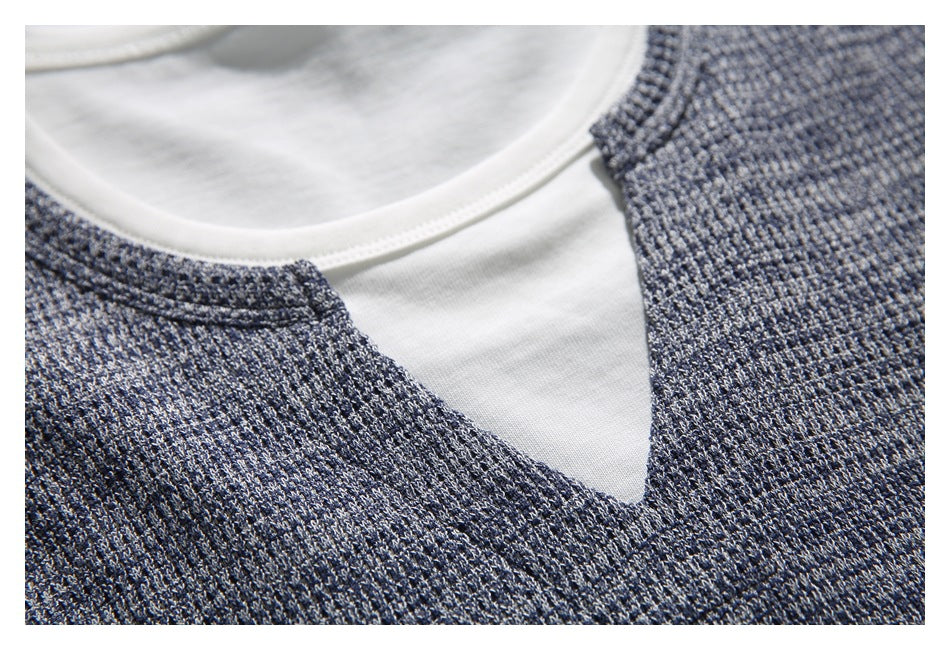 Close-up of the notched neckline showing the white inner layer and gray-blue textured outer fabric.