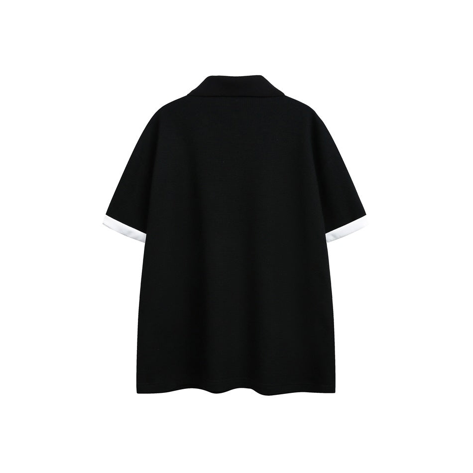 Back view of a black short-sleeve collared shirt with white sleeve cuffs.