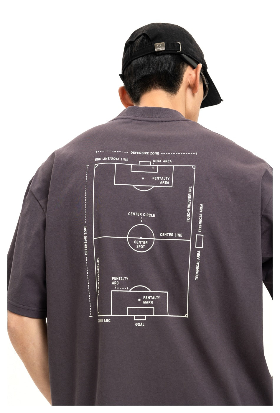 Back view of a charcoal T-shirt with a large white soccer-pitch diagram and English labels printed on it.