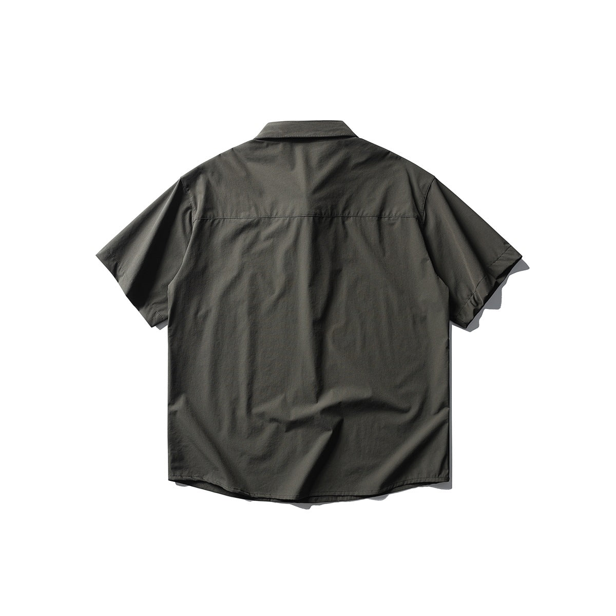 Back view of a dark gray short-sleeve shirt flat lay showing the yoke seam, collar and curved hem