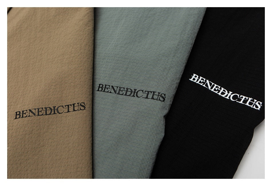 Close-up of three ribbed garment colorways in tan, muted gray-green, and black, each with a BENEDICTUS logo.