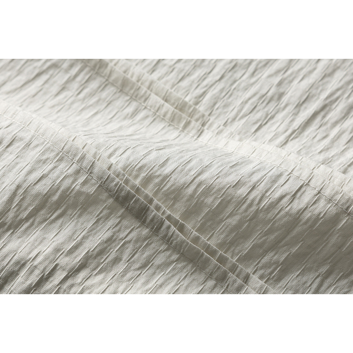 Close-up showing the off-white shirt's textured fabric and stitched seam.