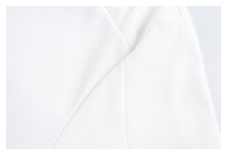 Close-up of white T-shirt fabric and stitched sleeve seam.