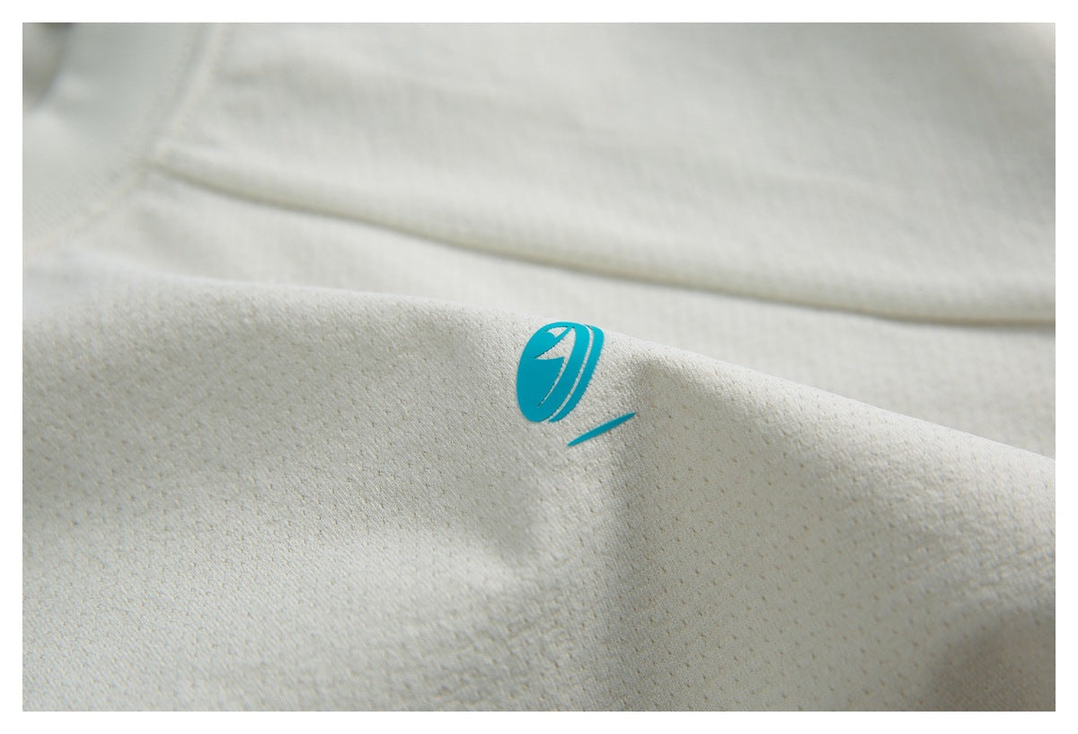 Close-up of the ivory perforated fabric and its small teal emblem.