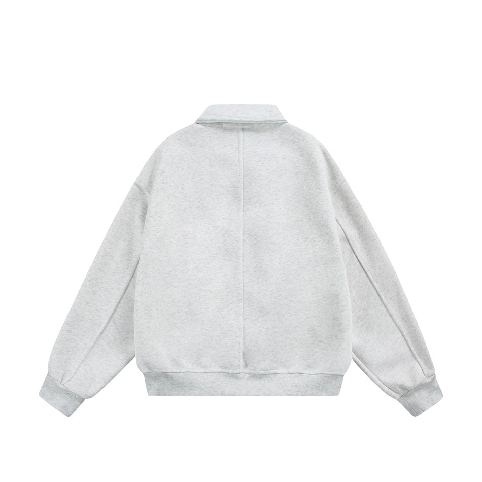 Back view of a light gray jacket with a center seam, pointed collar, and ribbed cuffs and hem.