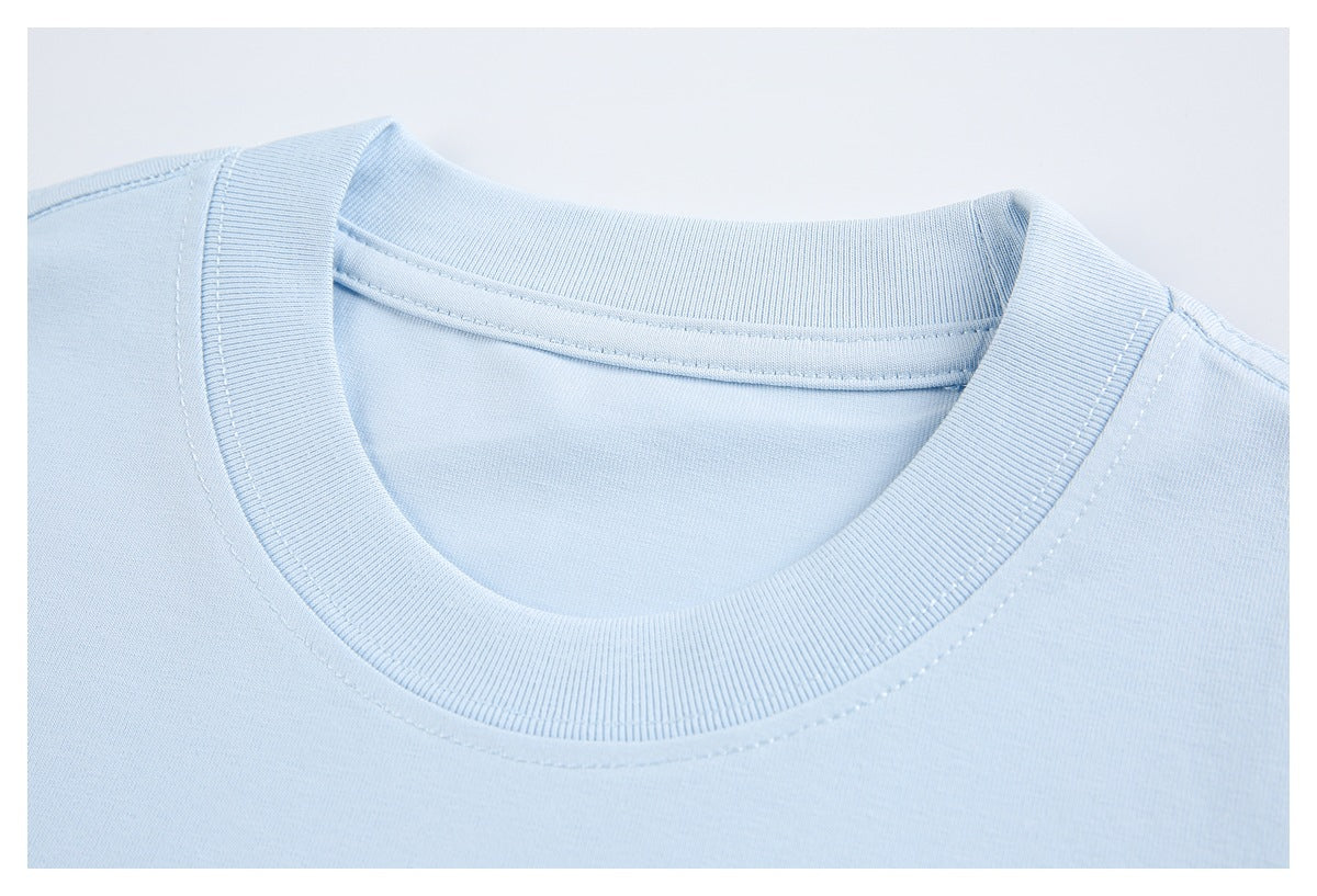 Close-up of the ribbed crew neckline and stitching on a pale blue T-shirt.