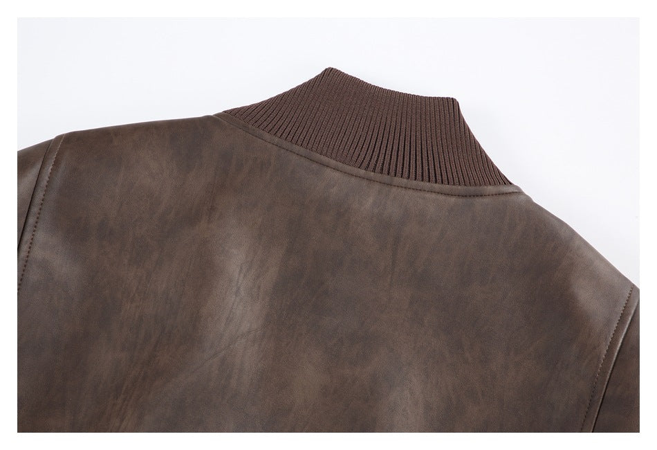 Close-up of a brown jacket shoulder and back with a ribbed brown collar.