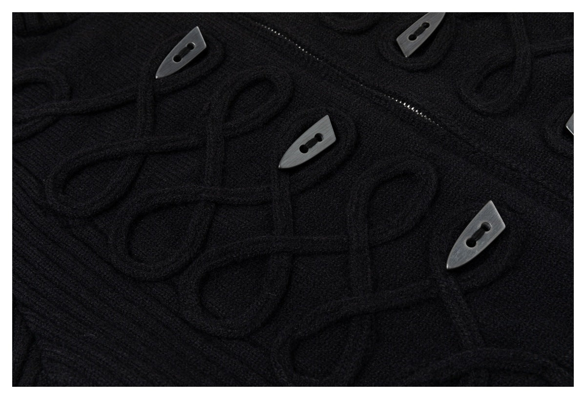 Close-up of raised loop details and dark toggle buttons on a black knit cardigan.