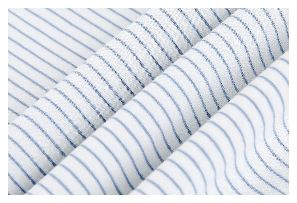 Close-up of folded white fabric with thin blue stripes.