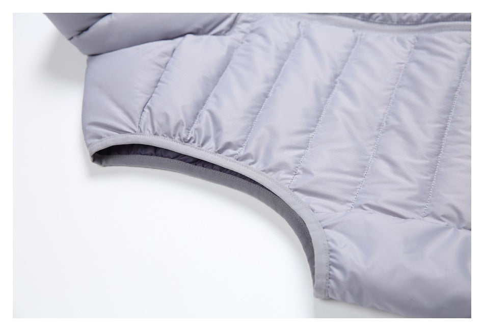 Close-up of the light gray-lavender vest's quilted side and bound armhole opening.