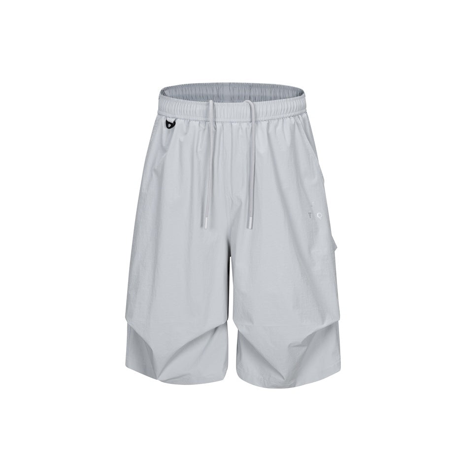 Light gray knee-length drawstring shorts with side flap pocket and layered pleated hem, front view