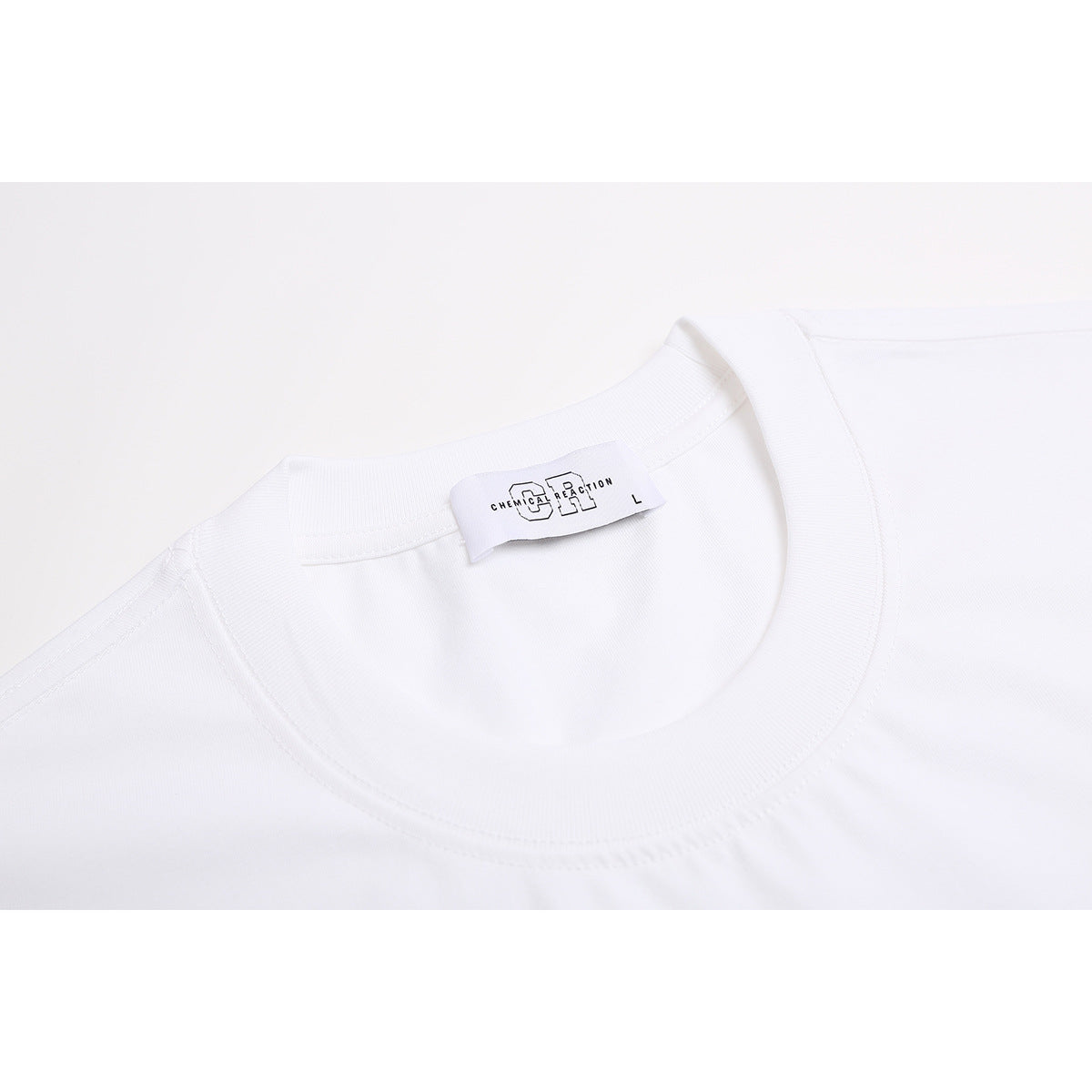 Close-up of a white T-shirt’s ribbed crew neck and inner label.
