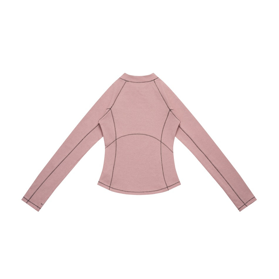 Back view of a dusty pink long-sleeve top with dark contrast seam stitching, laid flat.