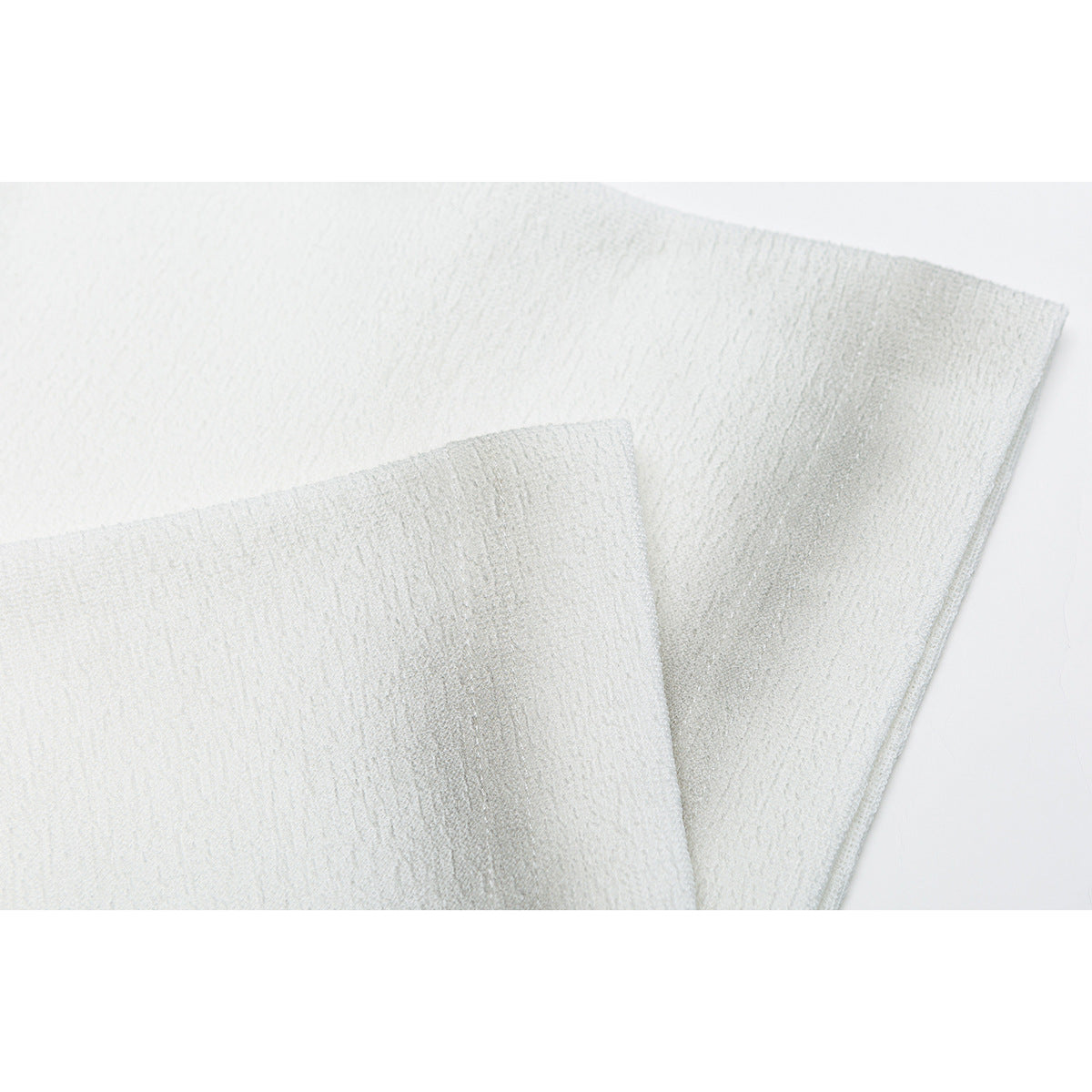 Close-up of overlapping white fabric panels showing a subtle textured weave.