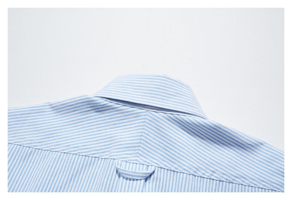 Close-up of the back collar and hanging loop on a blue-and-white striped shirt.