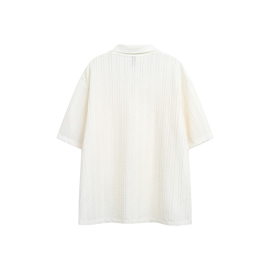 Back view of a white short-sleeve polo shirt with vertical textured stripes.