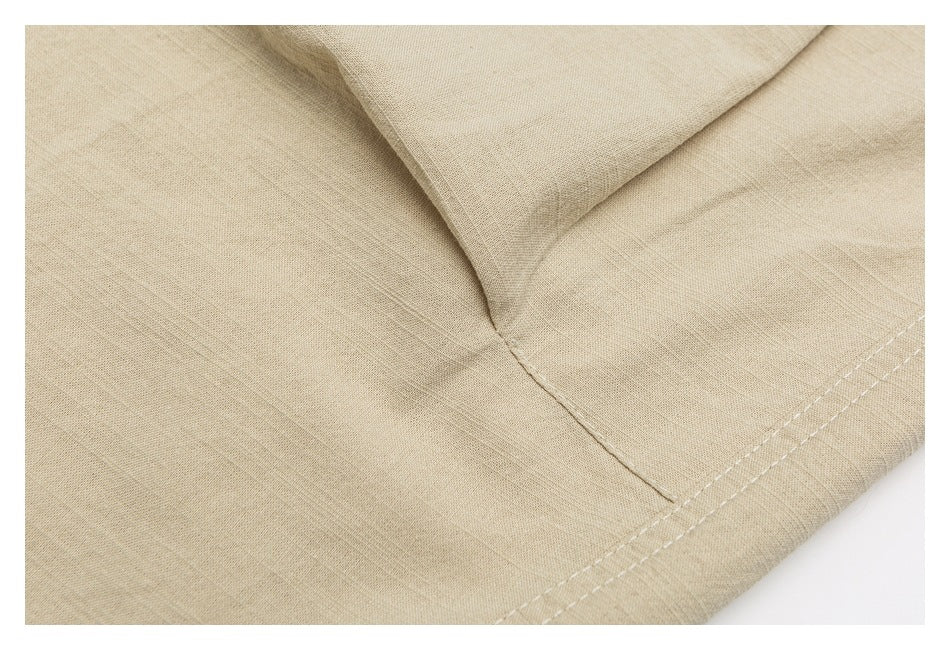 Close-up of beige bottoms showing a curved seam intersection and double-stitched edge.