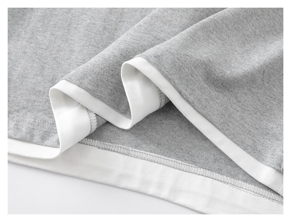 Close-up of heather-gray garment edges with white trim and visible overlock stitching.