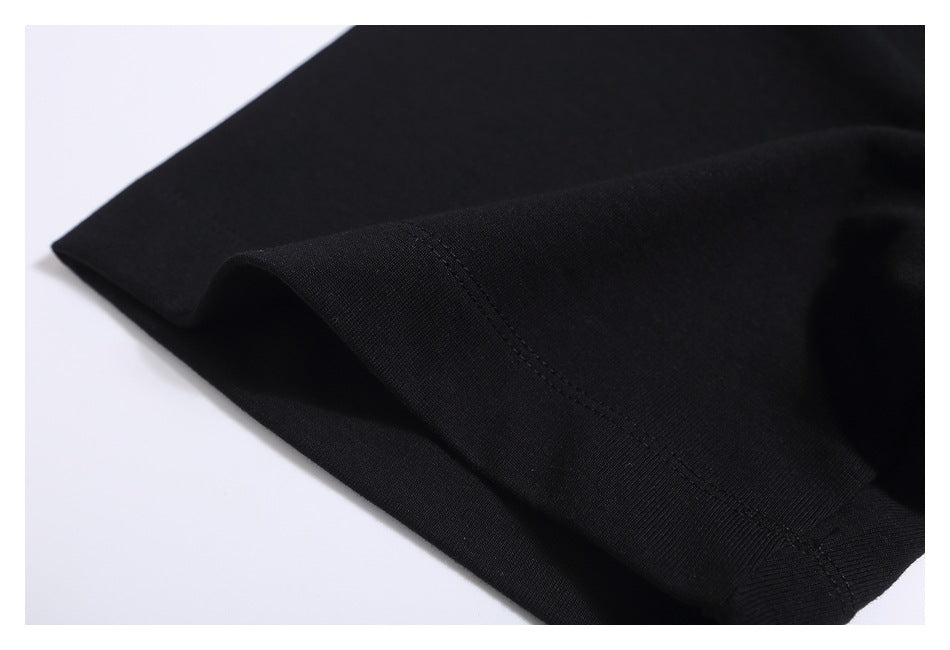 Close-up of black T-shirt fabric and double-stitched sleeve hem.